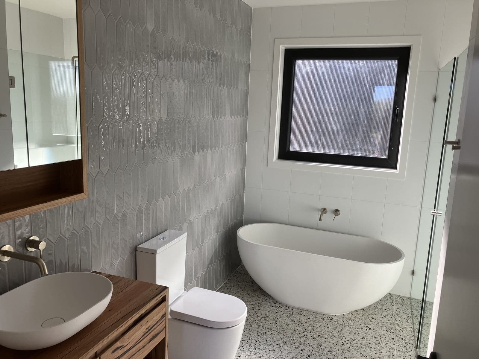 Bathroom with a freestanding bath and crisp painted walls