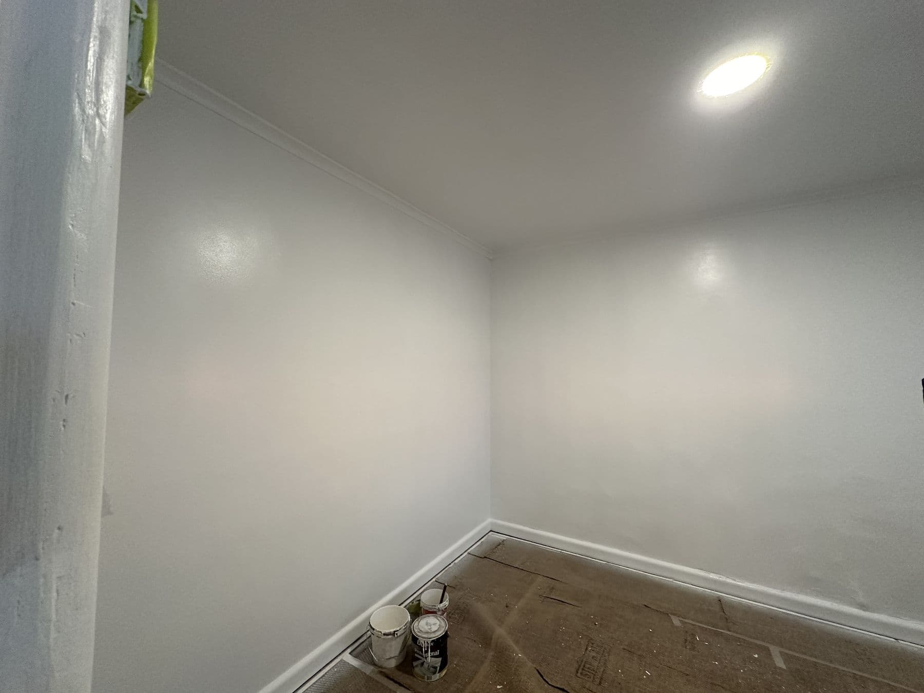 Light-filled freshly painted room with clean white walls and a window