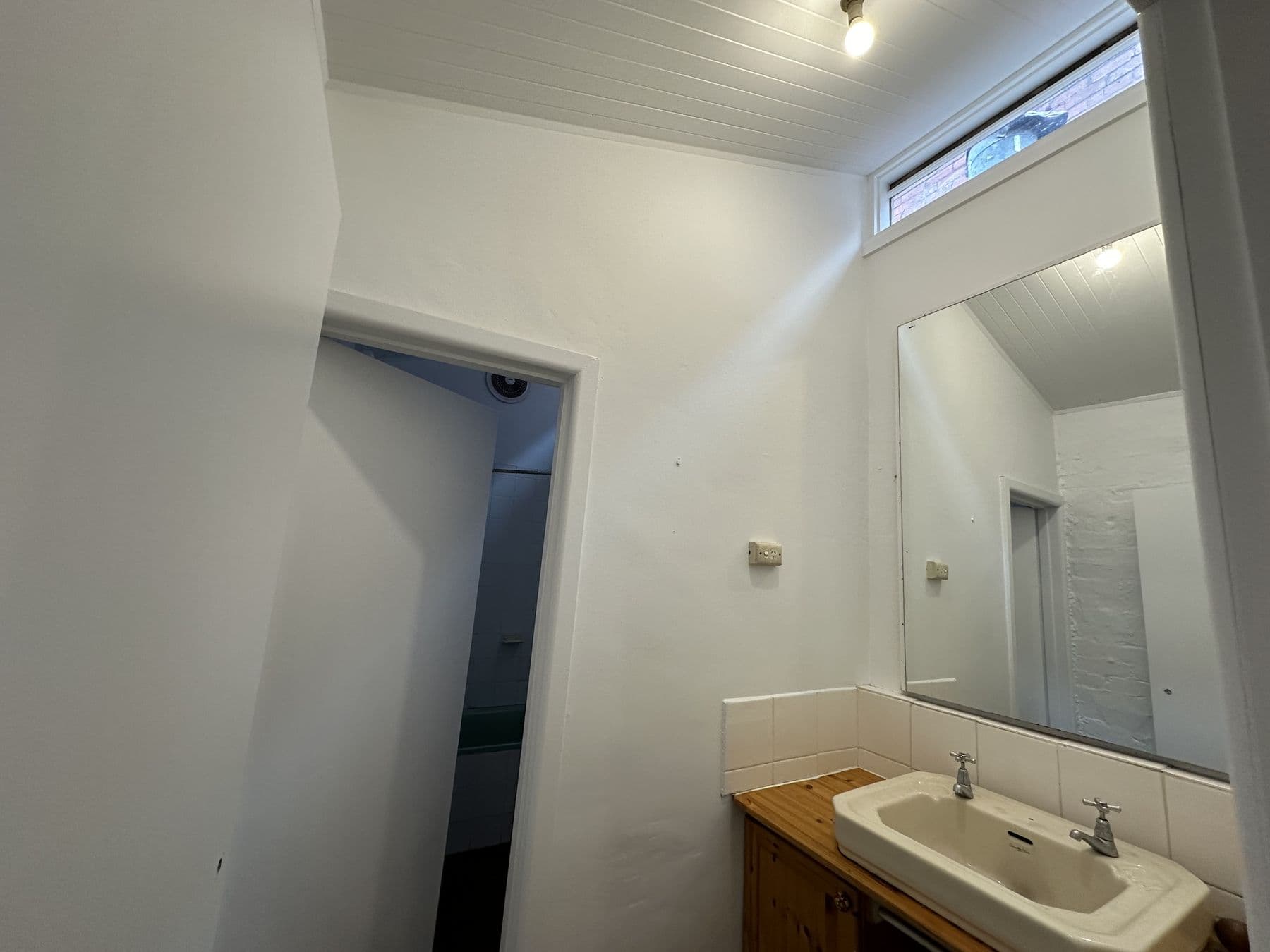 Bright hallway with a mirrored vanity and crisp white walls — finished Tricoat interior